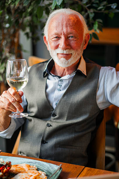 istock Senior businessman toasting at camera 2248579419