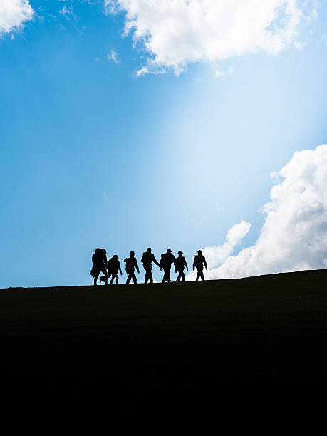 Silhouettes of travelers on the hill with blue sky, Doi Mongjong, Thailand