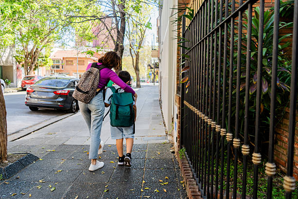 istock Mother and son walking on the city 2248582748