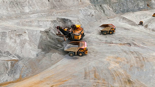 istock Giant mining excavator in the process of extracting rock material in an open pit mine 2248583632