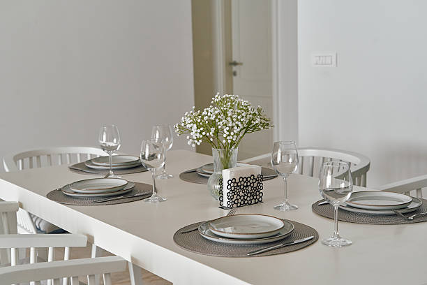 istock Elegant Dining Table with Glassware and Floral Centerpiece in a Minimalist Setting for Special Occasions or Casual Gatherings 2248583658