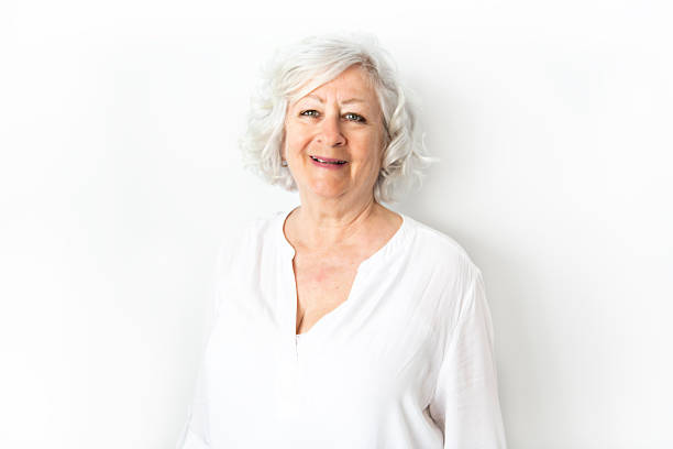 istock A Senior woman studio isolated on grey wall laughing cheerful 2248587944