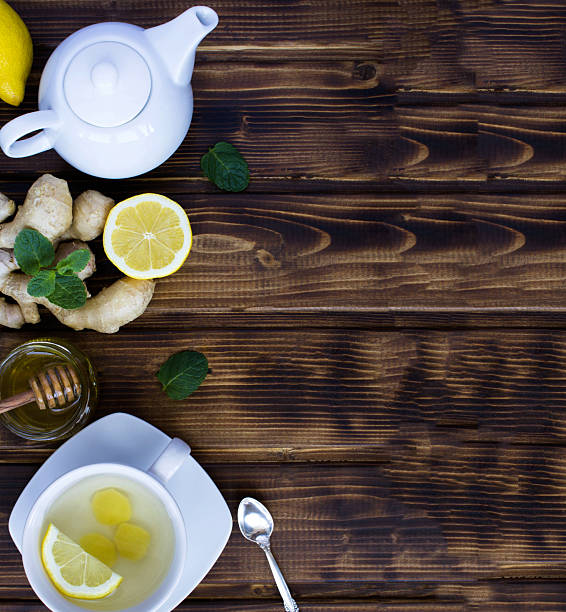 istock Ginger tea in the white cup and ingredients on a wooden background. Top view.Copy space. 2248588051
