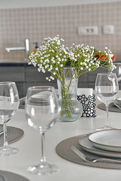 istock Elegant Table Setting with Delicate Flowers and Glassware for a Modern Dining Experience 2248589008