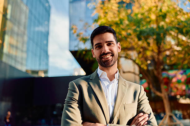istock Young businessman smiling confidently standing outdoors in city 2248589313