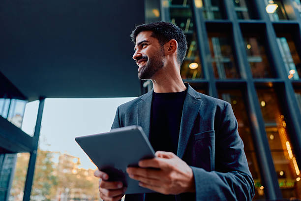 istock Businessman holding tablet smiling in urban environment 2248589716