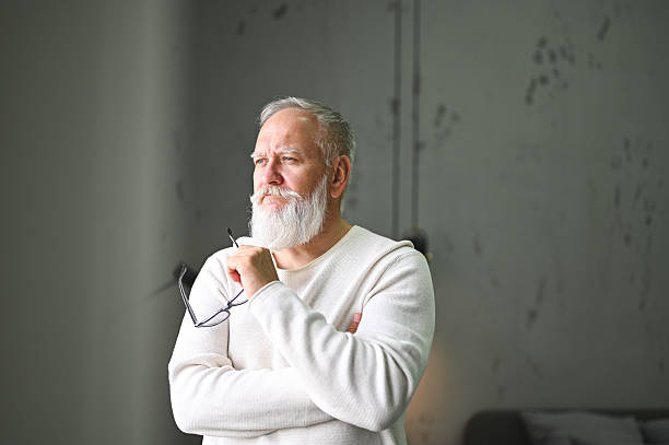 istock Senior man with white beard pensively looking away 2248589973