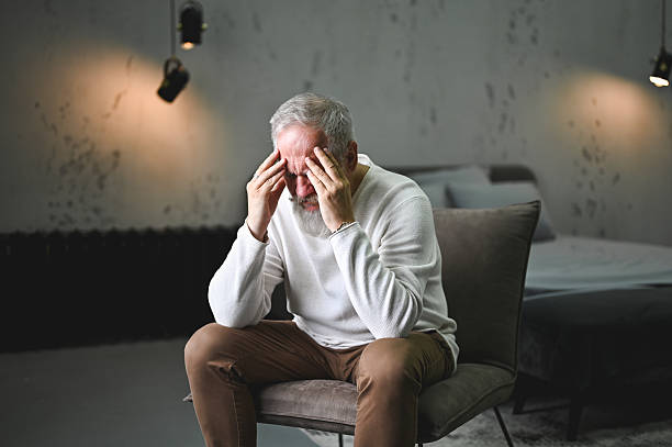 istock Senior man experiencing headache and mental stress at home 2248589998