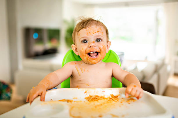 istock A Little baby eating her dinner and making a mess 2248590753