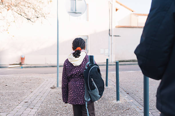 indian kid leaving home for first day of school at sunny day