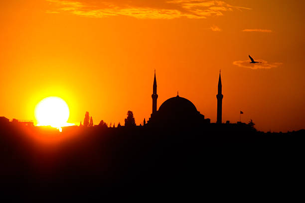 istock Turkish mosque silhouette with domes and minarets against sunset sky 2248591127
