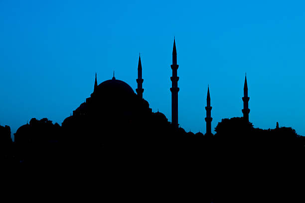 istock Turkish mosque silhouette with domes and minarets against sunset sky 2248591276