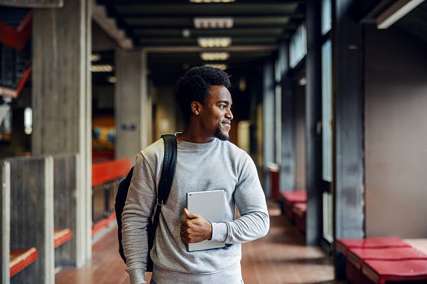 istock Young black man student walking university hallway 2248592457
