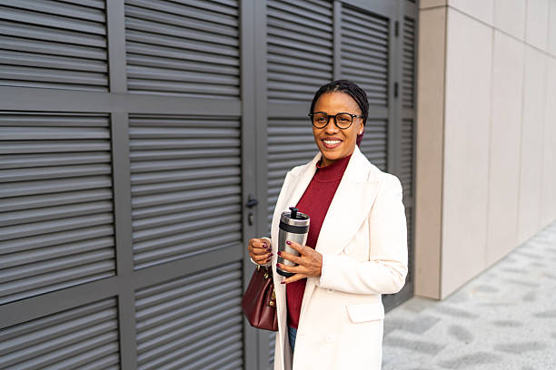 istock Professional black woman holding coffee mug downtown 2248593115