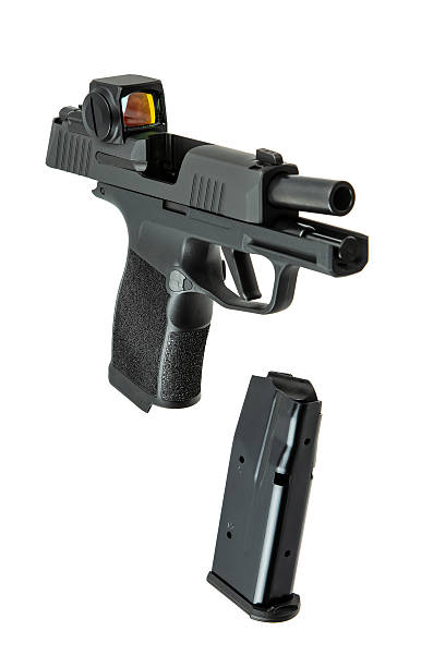 istock Pistol with slide open and magazine detached, featuring a red dot sight, isolated on white. 2248593440