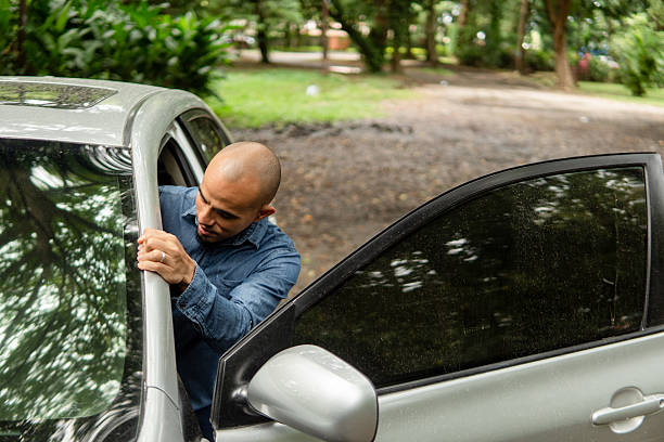 istock Bald man entering car in natural outdoor setting 2248597157