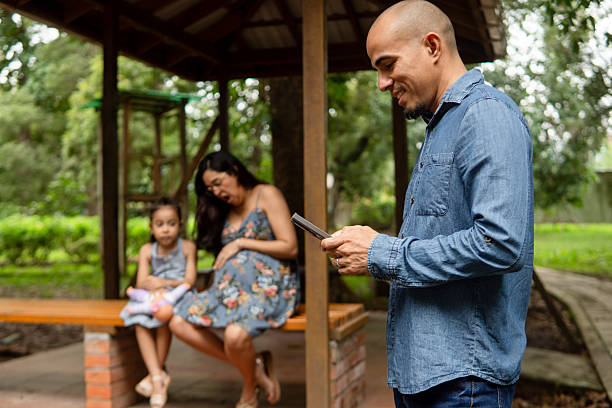 istock Father distracted by phone while family waits 2248598796