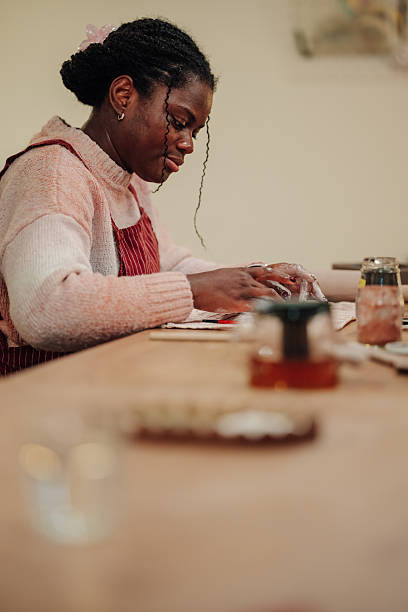 istock Young adult black woman working on pottery in studio 2248598922