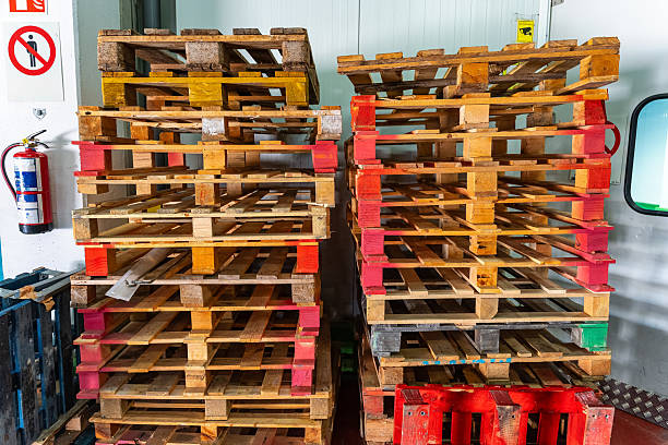 sunlight filtering through stacked wooden pallets