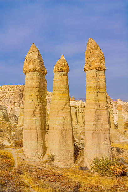 istock Cappadocia rock formations in Turkey under clear daylight, showing tall sandstone chimneys, textured cliffs, natural erosion shapes 2248600660