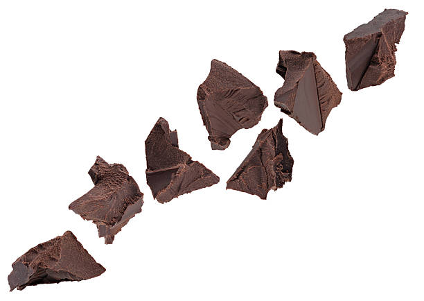 istock Chunks of crushed dark chocolate fly through space, forming a chain. Isolated on white. 2248604752