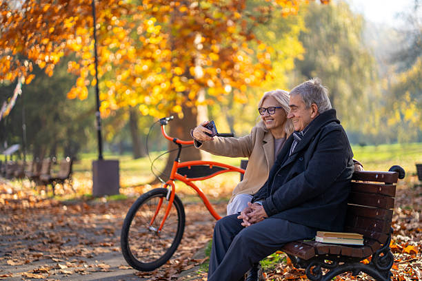 istock Senior couple enjoying autumn park making selfie 2248606451