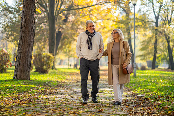 istock Senior couple enjoying autumn walk in park 2248606967