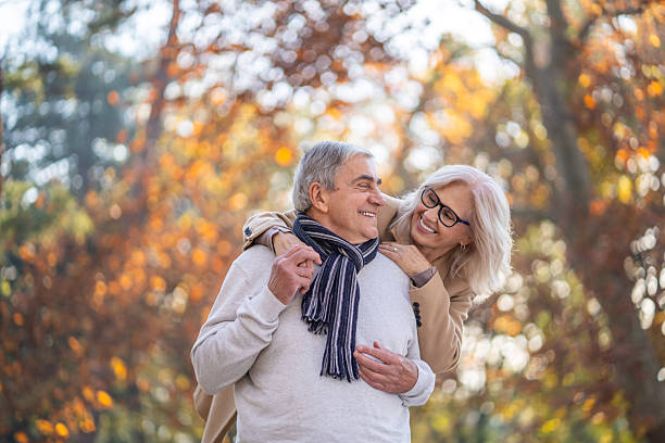 istock Senior couple embracing outdoors enjoying autumn park 2248607014