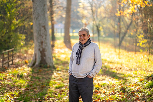 istock Happy senior man smiling in autumn park 2248607063