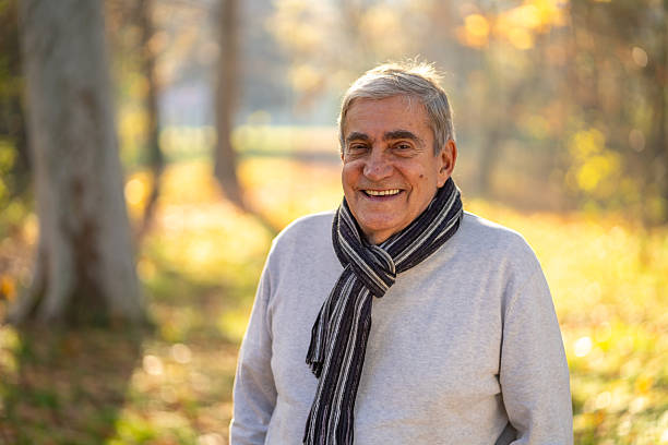 istock Senior man smiling in autumn park enjoying retirement 2248607076