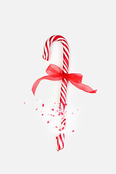 Candy cane broken into pieces with a red ribbon, creating a festive atmosphere during the holiday season