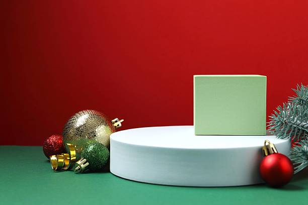 istock Christmas balls and white podiums on red background 2248609761