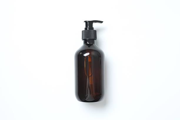 istock Brown cosmetic bottle on light background, top view 2248610308