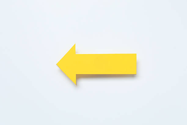 Paper arrow on white background, top view