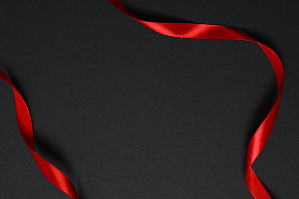 istock Stylish composition with red ribbon on black background, top view 2248610428