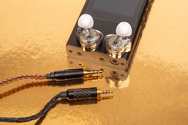 istock High-fidelity audio player with in-ear monitors and braided cables on a reflective surface 2248612904