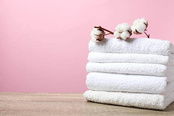 istock Stack of bath towels with cotton flowers on the table 2248613047