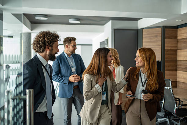 istock Business colleagues talking and smiling during an office break 2248619950