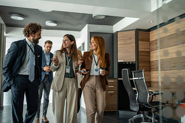 istock Business professionals walking discussing strategy in modern office 2248619959