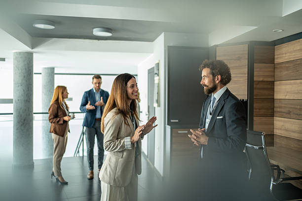 istock Business professionals networking at conference discussing during break 2248619981