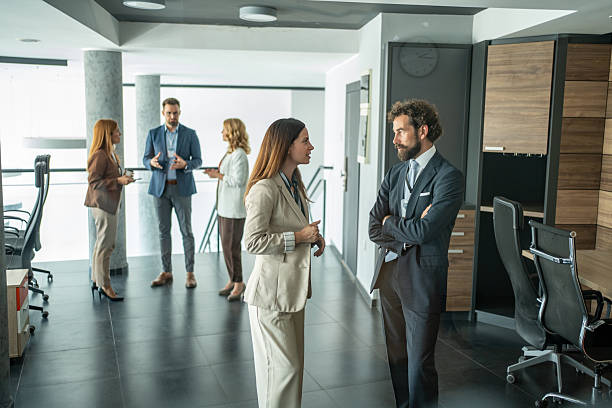 istock Business colleagues networking in modern office corridor 2248619982