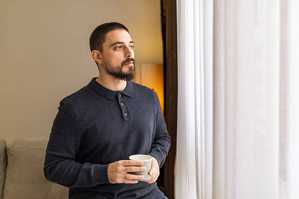 istock Handsome man with beard resting near the window at coffee time. 2248620677