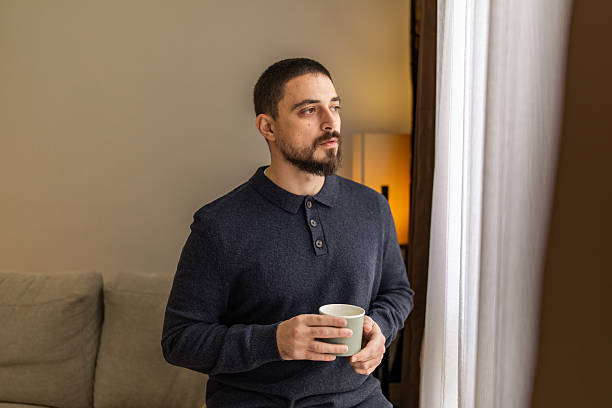 istock Handsome man with beard resting near the window at coffee time. 2248620683