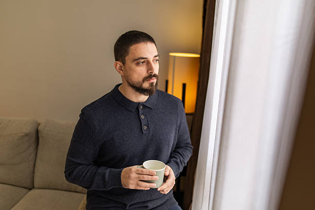 istock Handsome man with beard resting near the window at coffee time. 2248620687