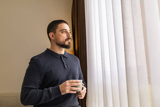 istock Handsome man with beard resting near the window at coffee time. 2248620695