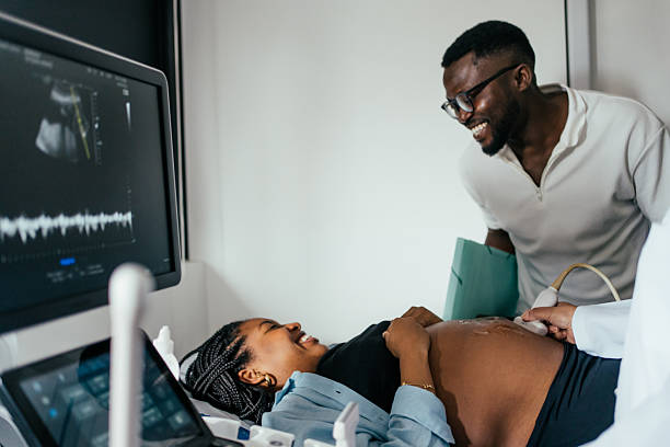 istock Black woman undergoing prenatal exam with her husband. 2248620840