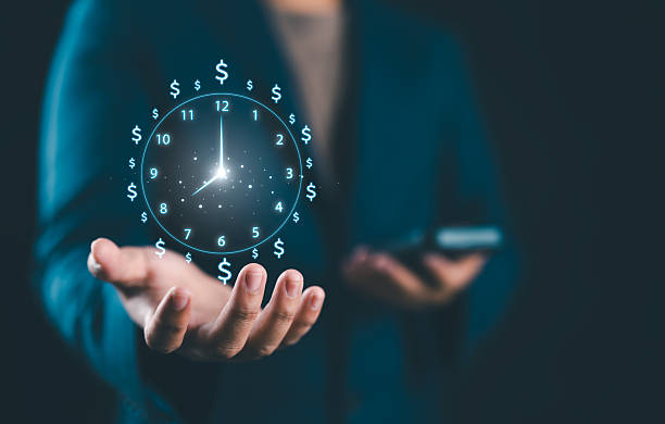 istock Time management concept, A person holding clock and money icon on interface virtual for business time management. Time is money, work planning increases efficiency and reduces work time. 2248621075