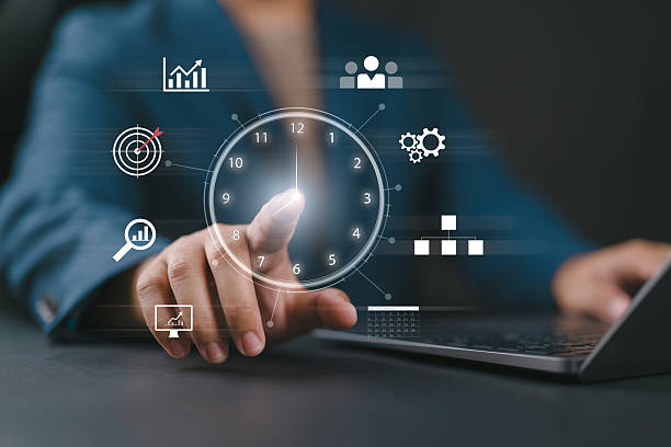 istock Time management concept. A person touching clock icon on virtual to work planning for increases efficiency and reduces work time. Business project planning. 2248621082