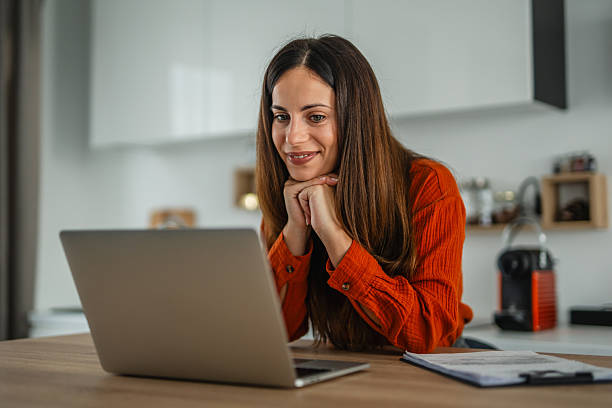 istock Woman smiling having video call working remotely from home 2248622729
