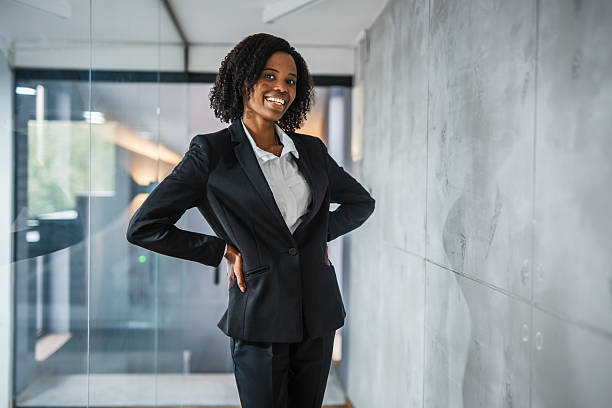 istock Confident businesswoman smiling posing in modern office hallway 2248623404